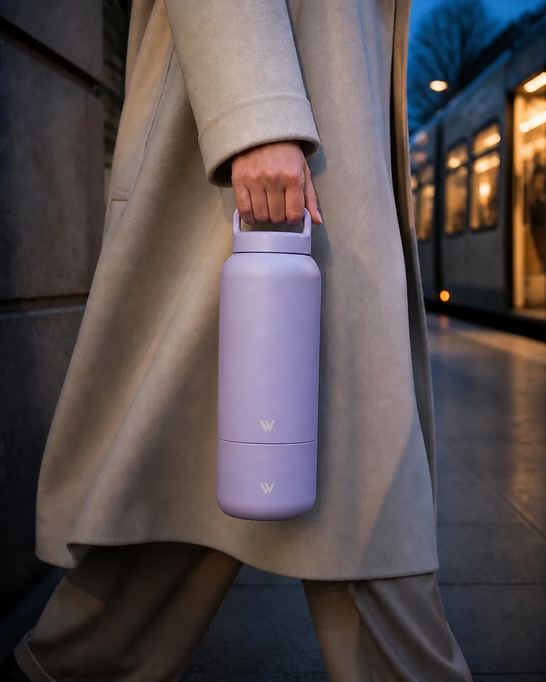 Lilac ViraVie bottle carried through the city at blue hour